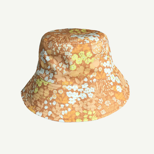 Orange and tonal yellows and neutral floral print  bucket hat with tonal top stitching detail on brim. 