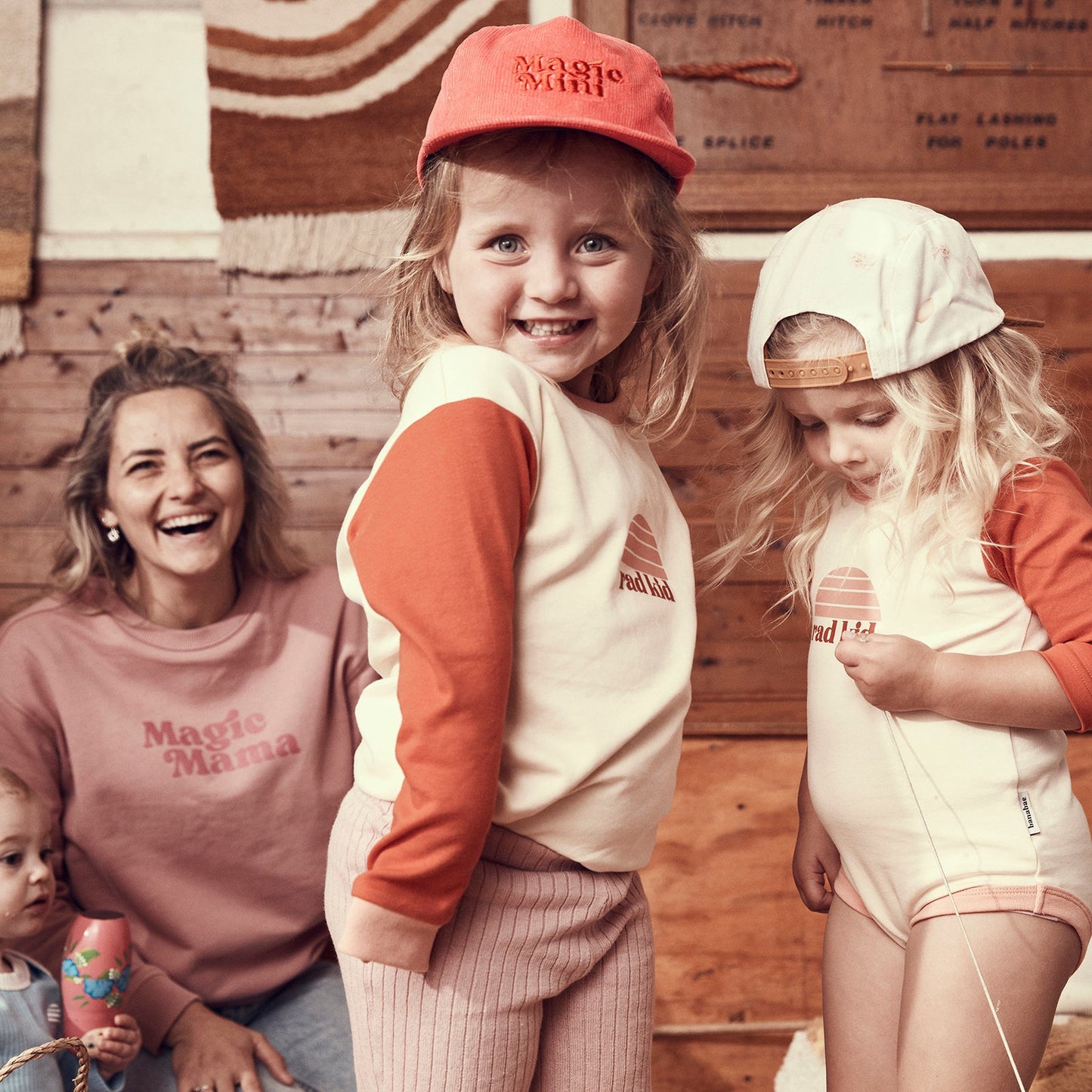 Lifestyle image of cute 4 year old wearing Banabae clothing and the Magic Mini Corduroy cap in pink with pink embroidery in darker tone of pink at center front.