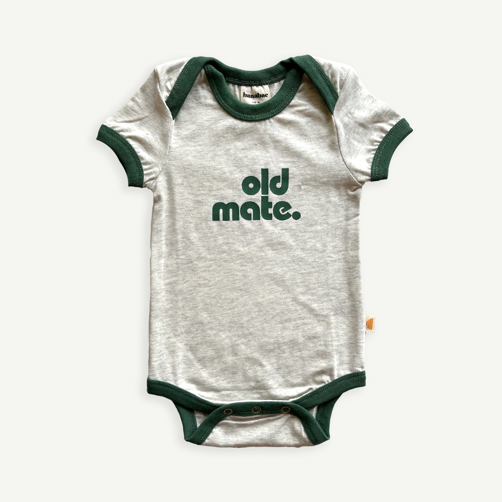 Natural grey marled base, baby onesie  with contrast green ringer bind at sleeve, neckline and hemp. With expandable Neckline for easy dressing and movement.  Old Mate in green printed at center front.
Snap Button opening at crotch for easy changing and d