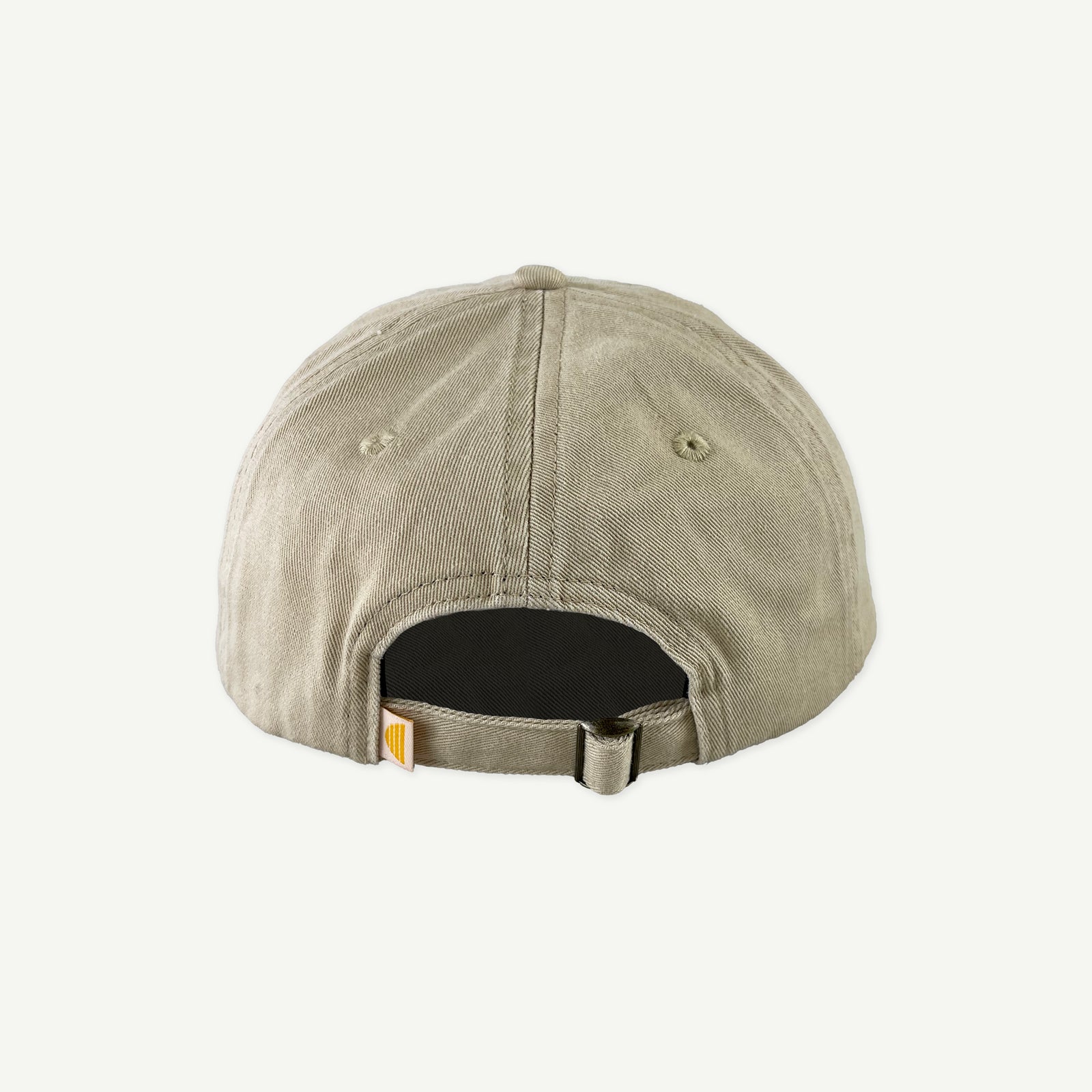 Back view of Banabae washed sand cap in organic cotton twill,  showing the center back bronze metal slid adjusted at back.