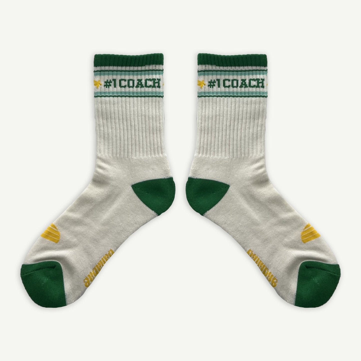 #1 Coach socks, White crew socks with #1 coach in Green written horizontally, bordered with a green and aqua stripe. Toe and heal pads in contrast green with Banabae written along the sole in yellow, and the iconic  Banabae sun logo in yellow placed on to