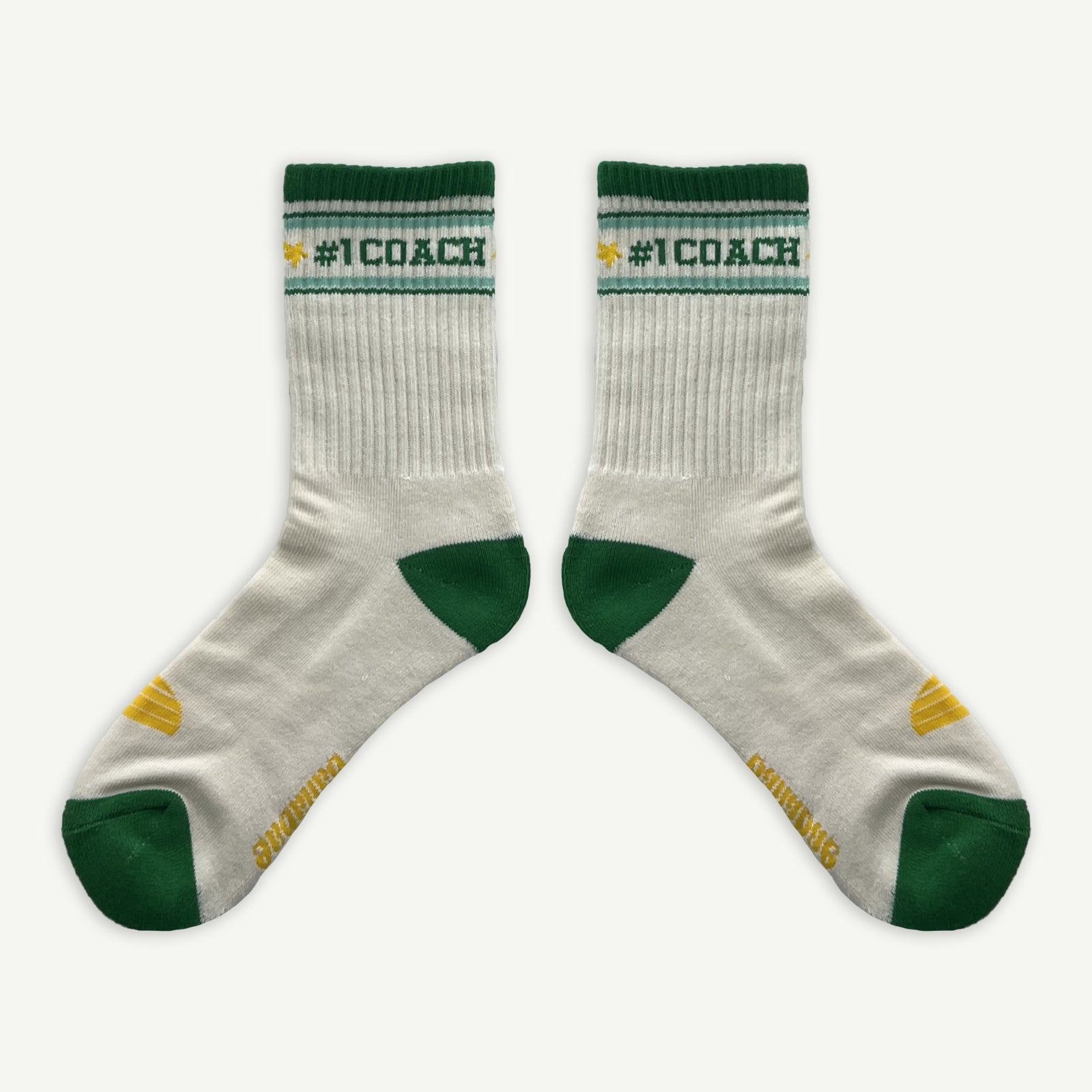 #1 Coach socks, White crew socks with #1 coach in Green written horizontally, bordered with a green and aqua stripe. Toe and heal pads in contrast green with Banabae written along the sole in yellow, and the iconic  Banabae sun logo in yellow placed on to