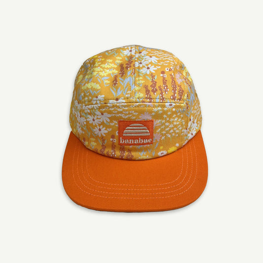 5 Panel cap in orange floral ditsy print with contrast orange peak and  orange patch with the Banabae sun logo and Banabae embroidered in off white.