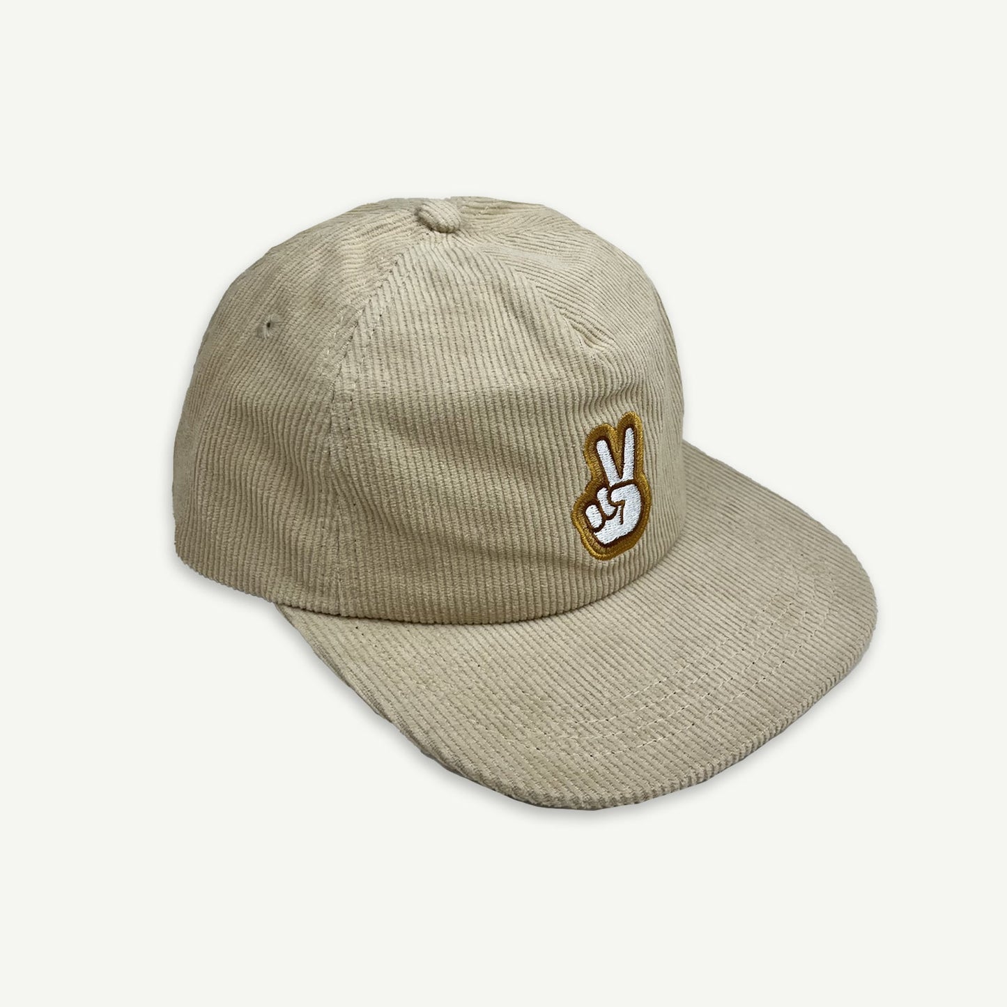 off centered view of Ecru cord pinch front flat Cap with V-Sign representing peace embroidered in white, with thin brown boarder and larger boarder in golden yellow